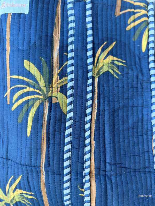 Blue fabric with palm tree pattern and striped border