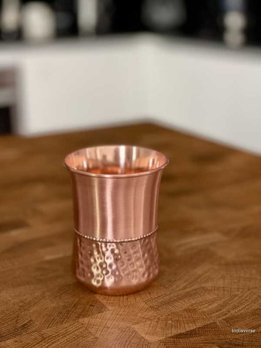 polished copper cup with hammered details made for serving water and healthy alternative to glass