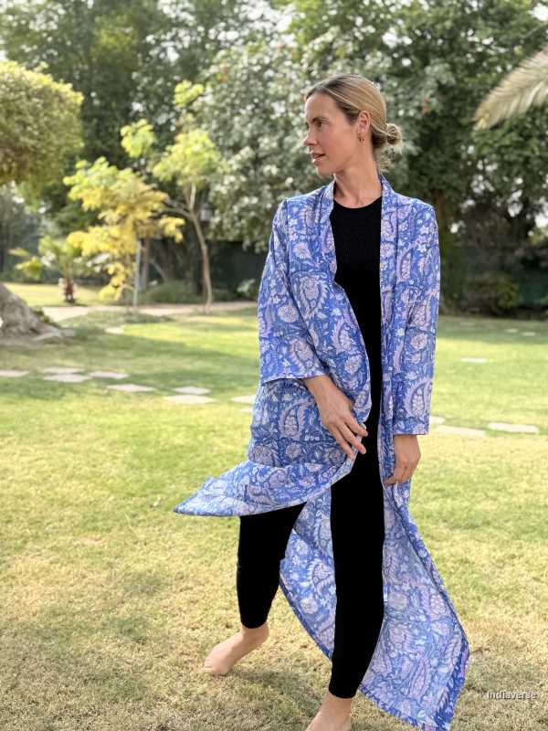 Woman wearing a blue patterned coat in a park