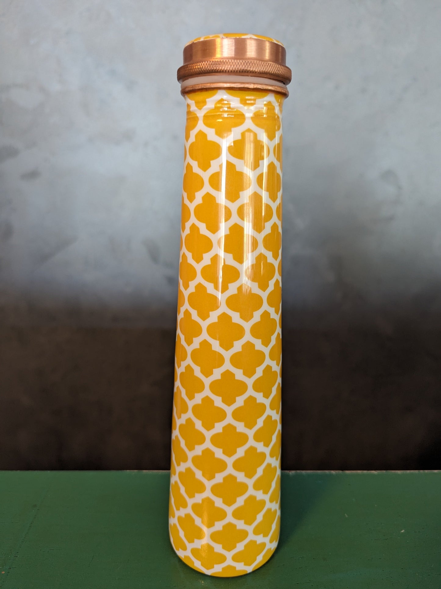 copper bottle tower shaped made from copper and enameled with symmetric yellow design for drinking water
