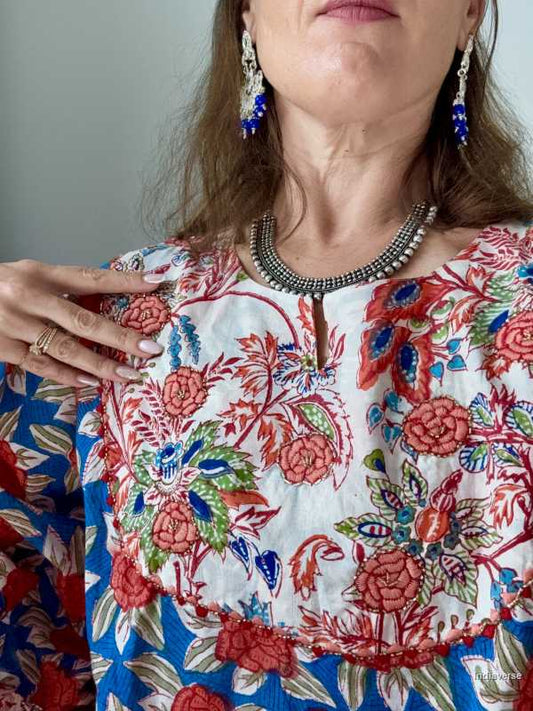 Close up of a woman wearing a colorful floral dress with intricate patterns