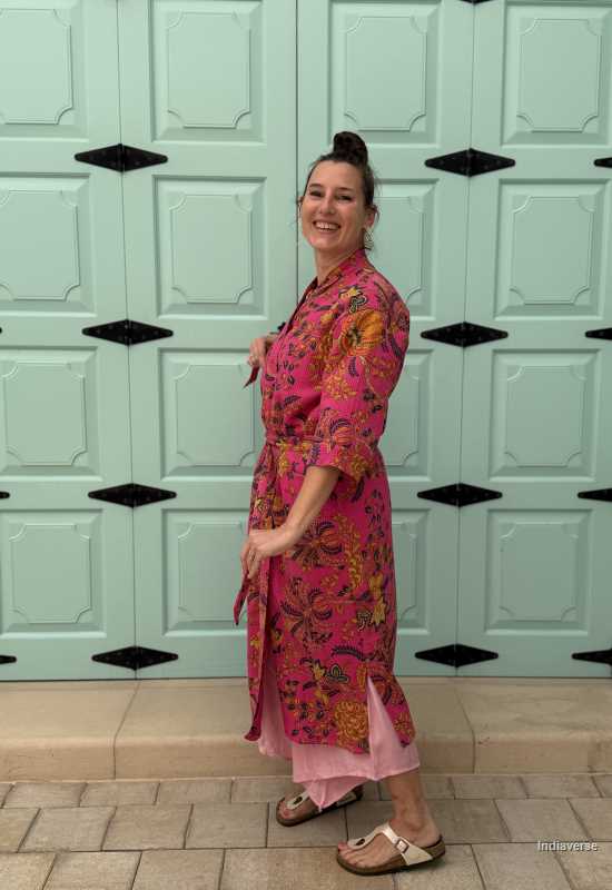 Model wearing a hot pink waffle cotton bathrobe with a relaxed fit, tie belt, and pockets, showcasing the lightweight and breathable fabric.