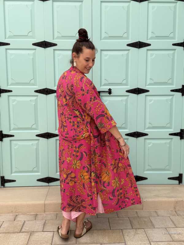 Model wearing a hot pink waffle cotton bathrobe with a relaxed fit, tie belt, and pockets, showcasing the lightweight and breathable fabric.