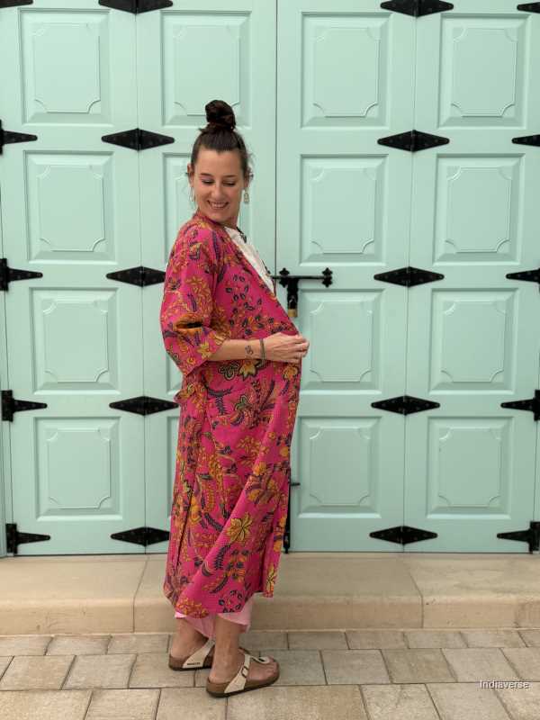 Model wearing a hot pink waffle cotton bathrobe with a relaxed fit, tie belt, and pockets, showcasing the lightweight and breathable fabric.