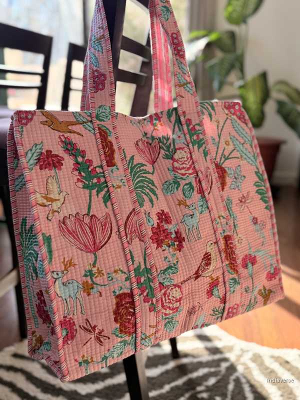 Floral patterned tote bag with colorful designs on a chair.