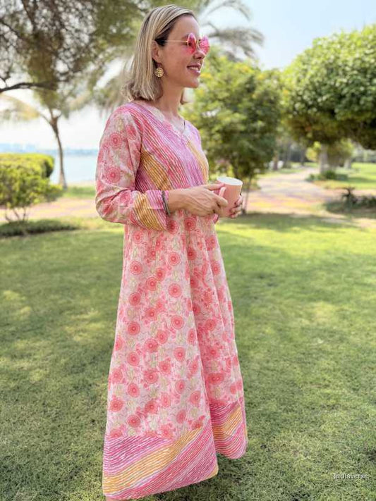 Woman in a pink floral dress standing in a park