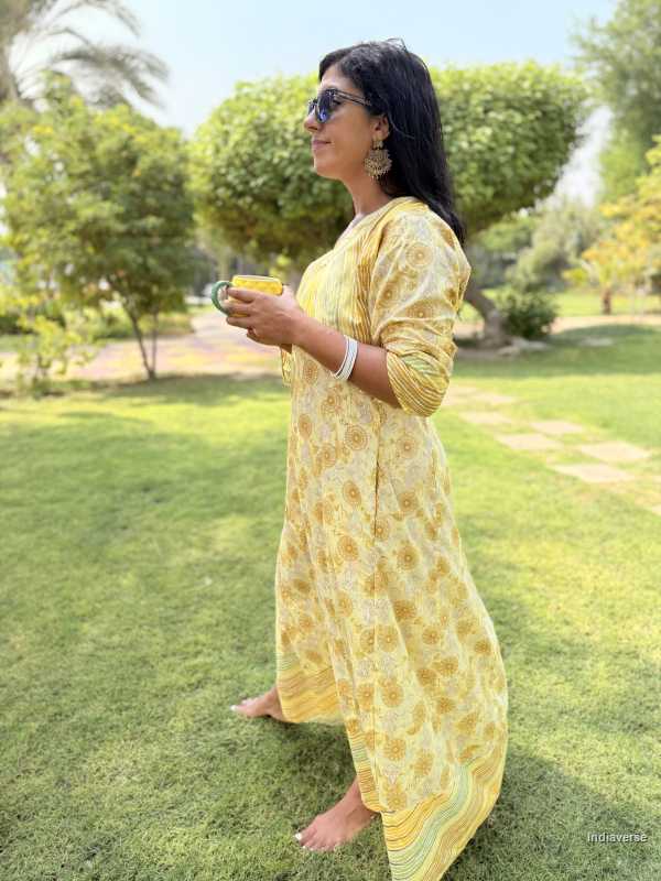 Woman in a yellow dress standing in a park