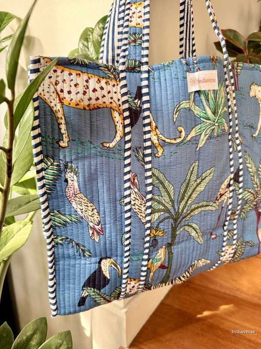 Tropical-themed bag with leopards, toucans, and palm trees on a blue background.