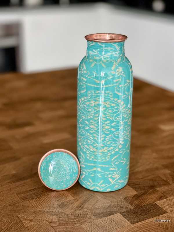 Turquoise color enameled copper bottle with ethnic design for storing drinking water with a capacity up to 600 ml