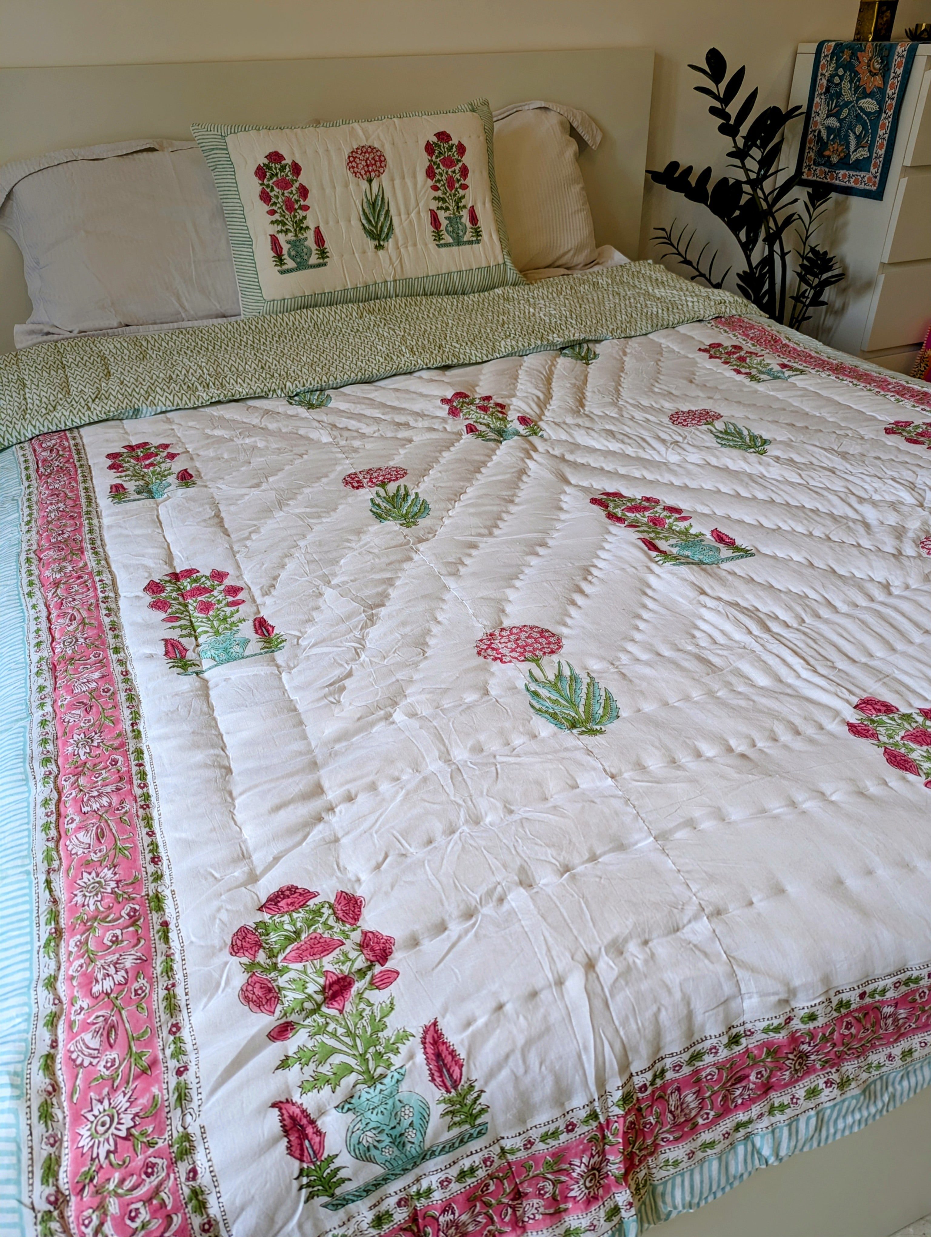 beautiful quilt with pink and green flower design perfect for the bed or sofa