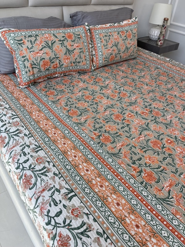 orange floral comforter set on king size bed with two matching pillow cases