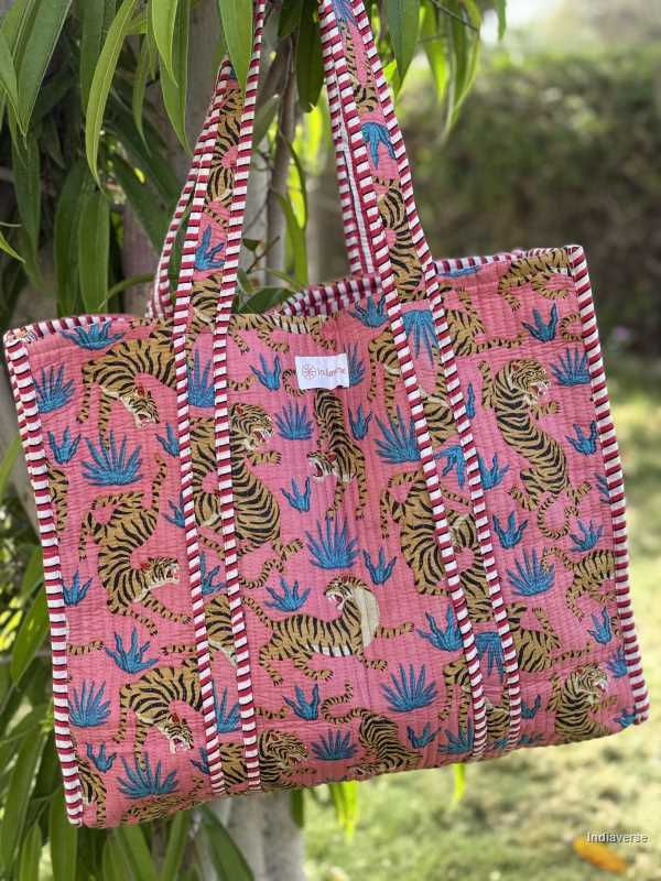 pink quilted cotton toe bag with tiger design hanging on a green tree