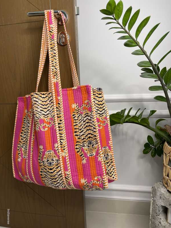 pink orange cotton tote bag hanging from a door handle