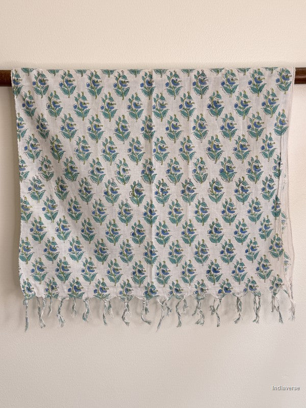 cotton scarf with tiny blue flower motif hanging on a wooden beam