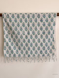 cotton scarf with tiny blue flower motif hanging on a wooden beam