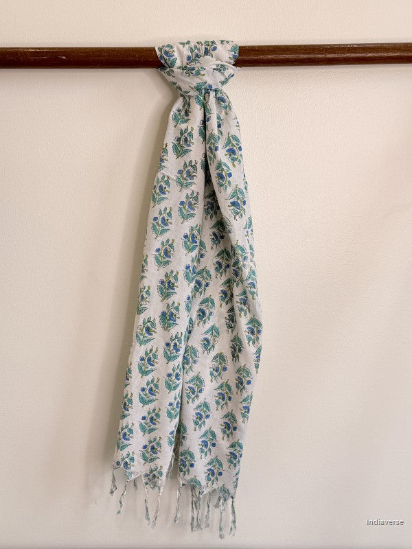 Cotton scarf with small blue flowers tied to a wooden beam