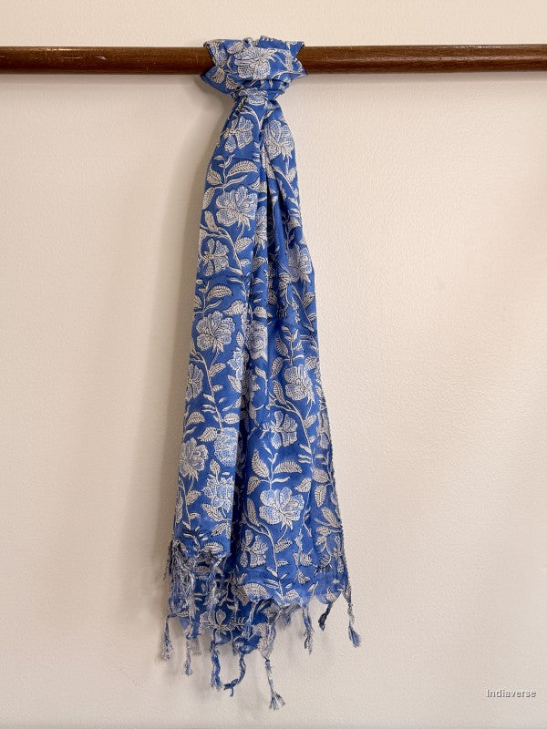 blue cotton scarf with white floral design tied to a wooden beam