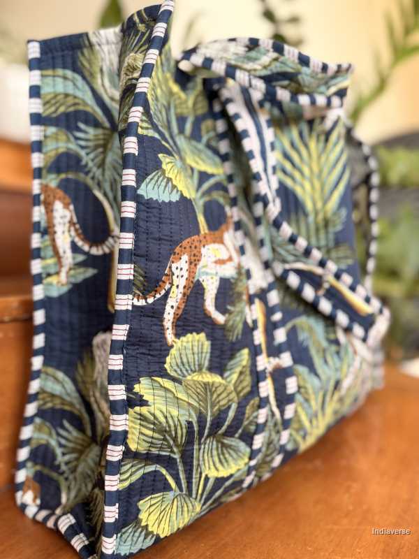 Fabric basket with jungle-themed design featuring leopards and foliage on a wooden surface.
