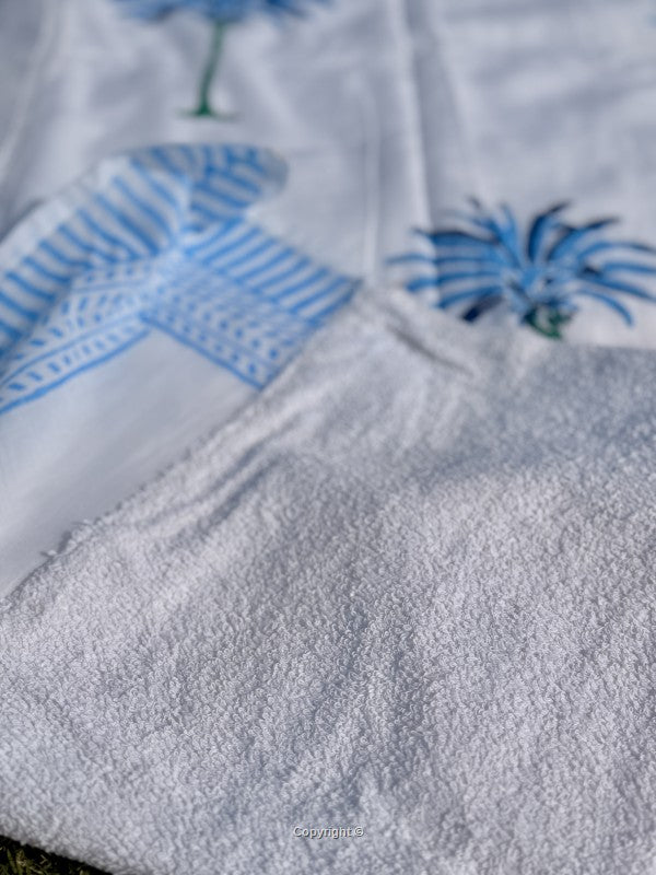 Close-up of a textured fabric with blue floral patterns on a white background