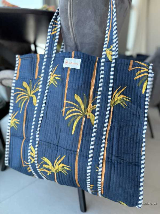 Blue tote bag with palm tree design on a mannequin