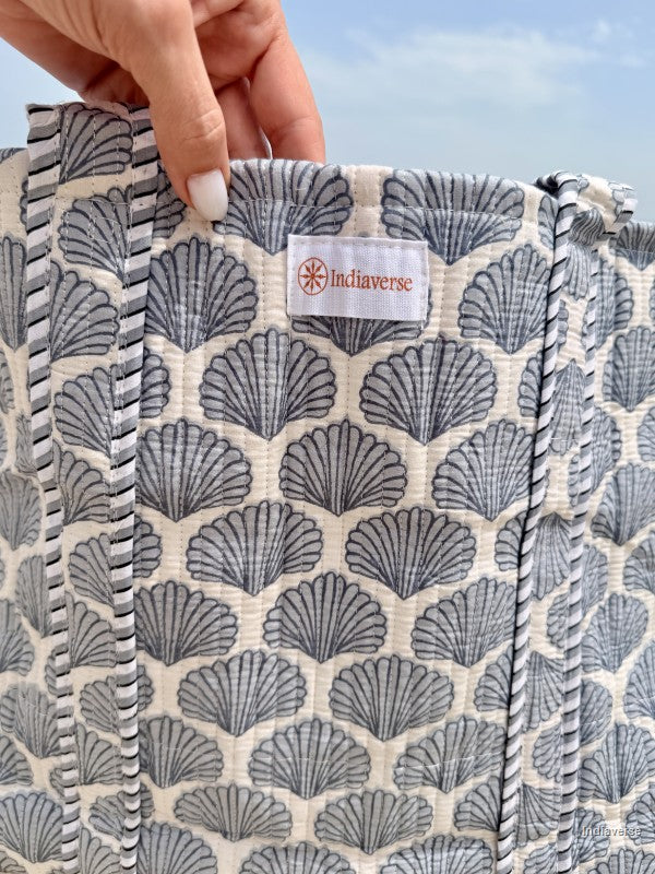 Close up of Indiaverse logo on the front of the tote bag with blue sea shells