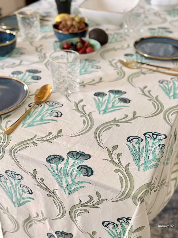 Decorative tablecloth with floral pattern on a set dining table