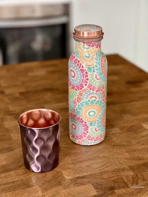 pastel colored enameled copper bottle with lid and with colorful ethnic design for drinking water up to 600 ml capacity