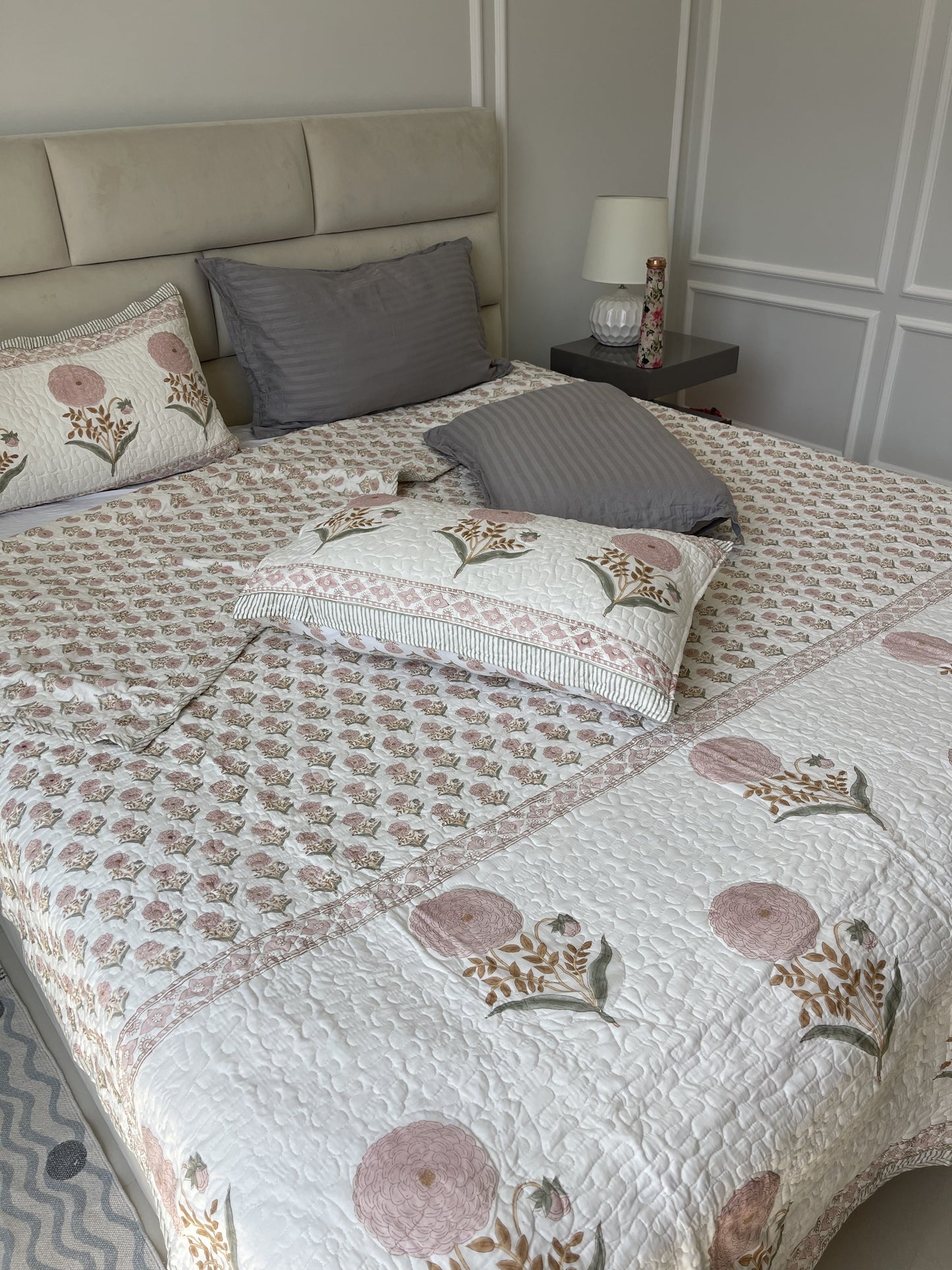 Hand block printed cotton comforter with pink floral design for king or queen size bed