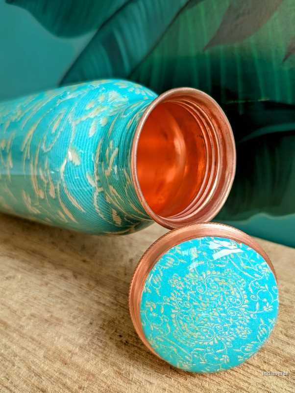 Turquoise color enameled copper bottle with ethnic design for storing drinking water with a capacity up to 600 ml