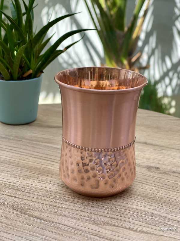 polished copper cup with hammered details made for serving water and healthy alternative to glass
