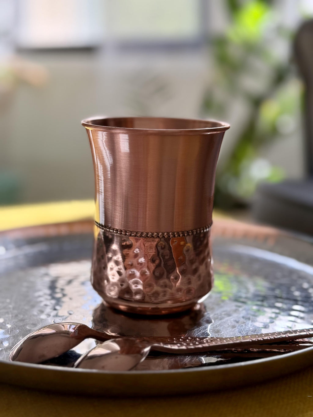 curved polished copper tumbler with hammered details made from pure copper made for drinking water