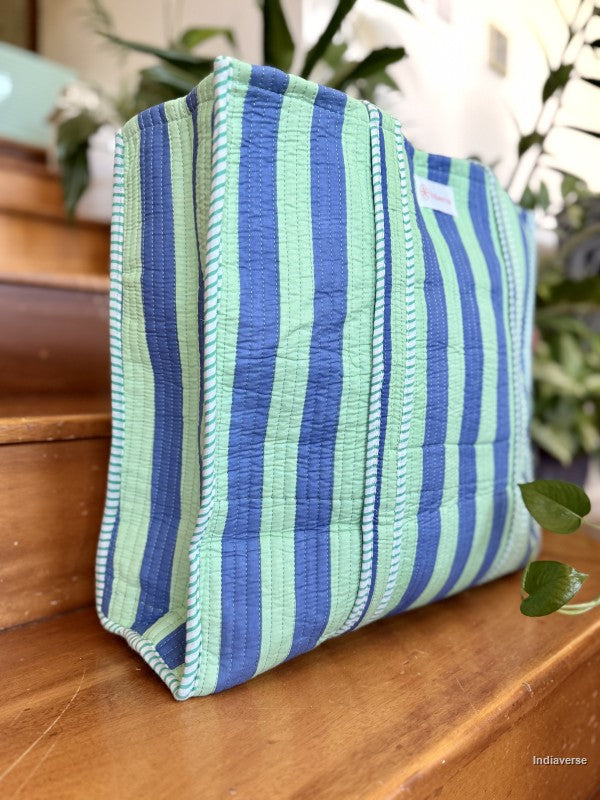 striped bag with blue and green color sitting on a wooden surface