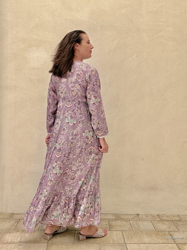 Woman wearing a floral dress against a beige wall