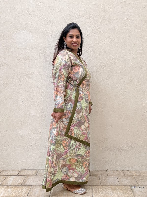 Side view of a woman wearing a spring green floral dress against a beige wall