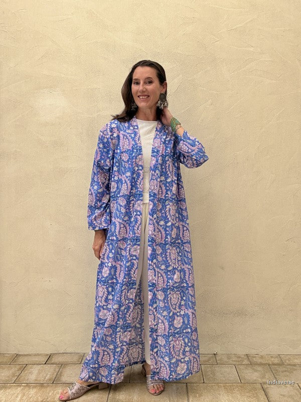 woman wearing a long abaya with paisley print on blue and pink