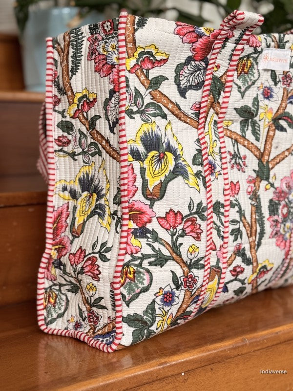 side view of a quilted tote bag with floral design