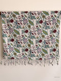 cotton scarf with floral design hanging from a wooden beam