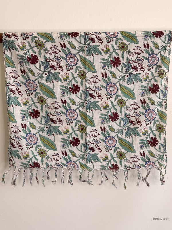 cotton scarf with floral design hanging from a wooden beam