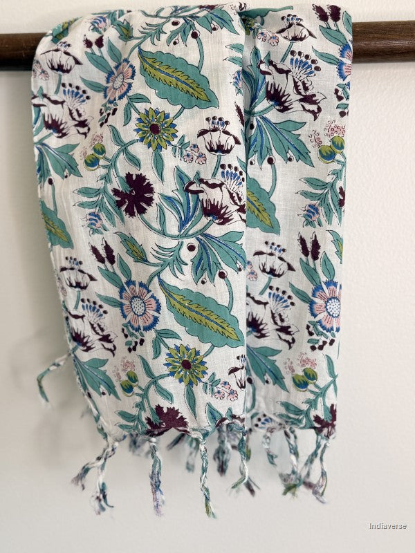 cotton scarf with floral design hanging from a wooden beam