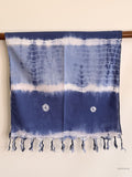indigo blue cotton scarf hanging from a wooden beam