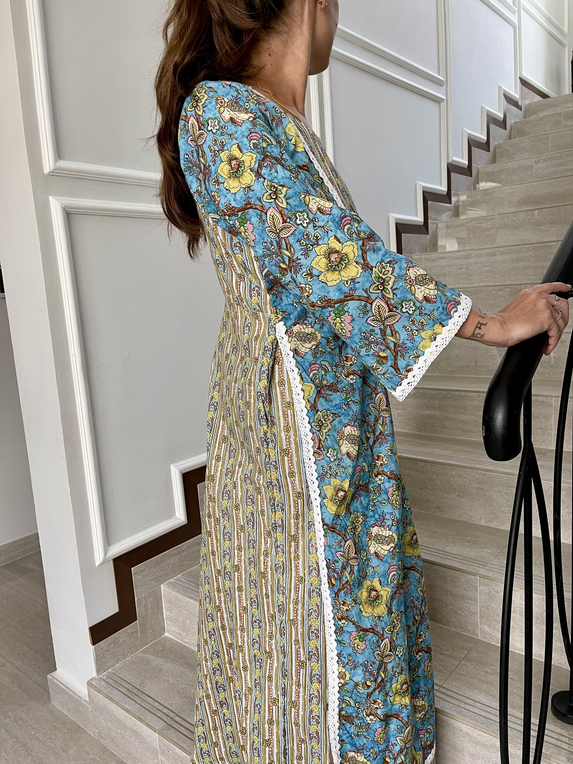 Long-cotton-dress-two-layered-look-with-white-lace-border-detail-and-blue-beige-yellow-floral-design-and-full-length-sleeves