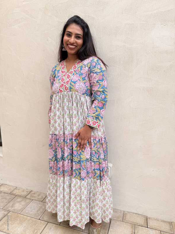 Woman wearing a floral dress lying on a tiled floor