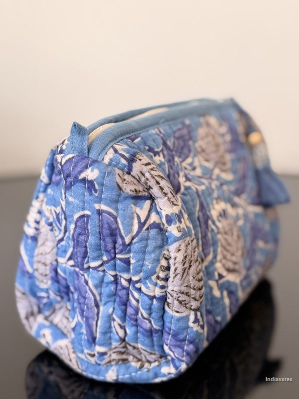blue floral pouch sitting on a glass surface