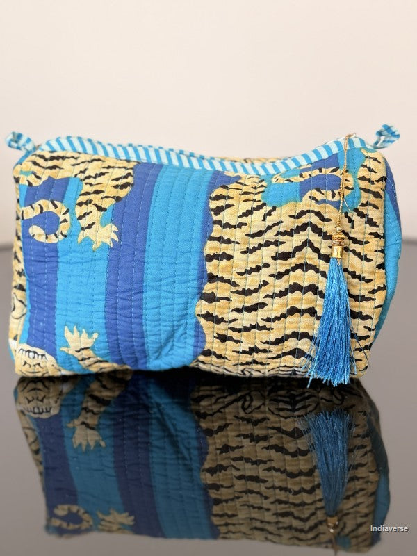 blue striped pouch with tiger print sitting on a glass surface