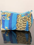 blue striped pouch with tiger print sitting on a glass surface