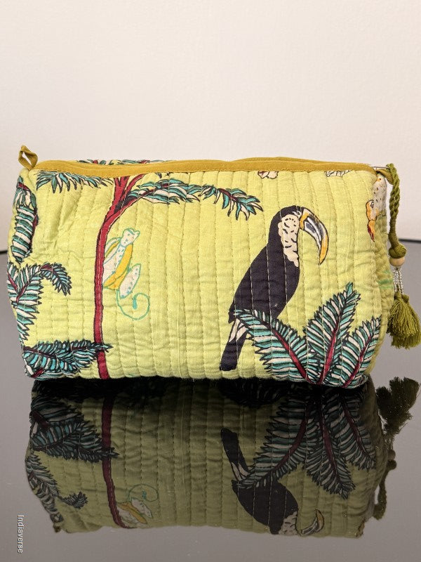 lime color toiletry pouch with jungle print sitting on a glass surface