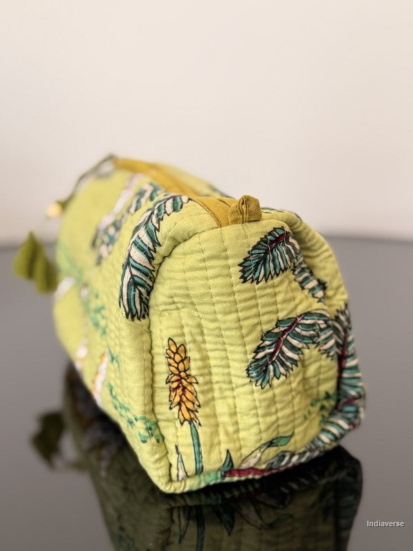 backside of the lime pouch with jungle print on a smooth surface