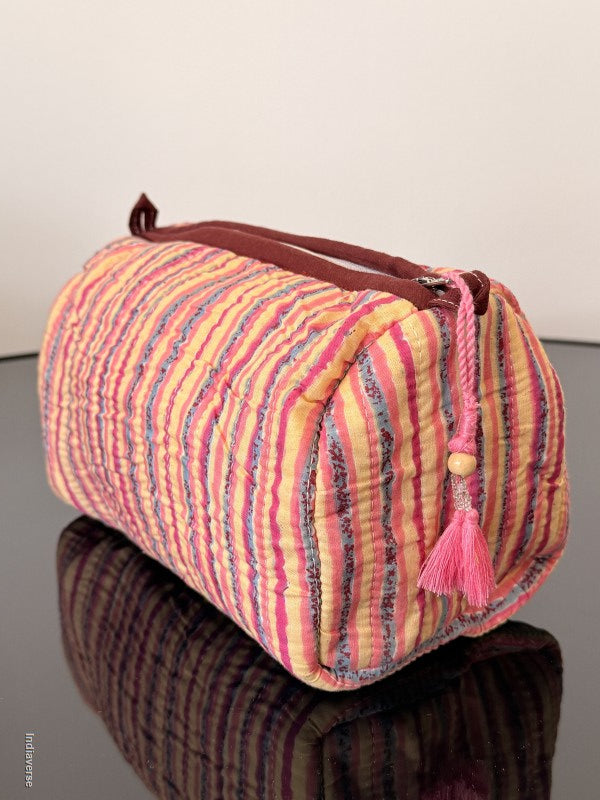 Colorful drawstring bag with a tassel on a plain background