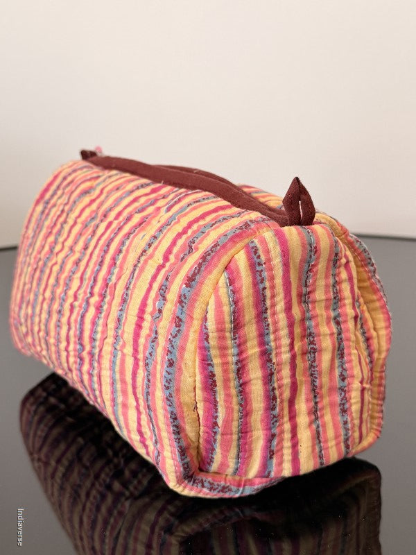 Striped fabric bag with drawstring on a plain background