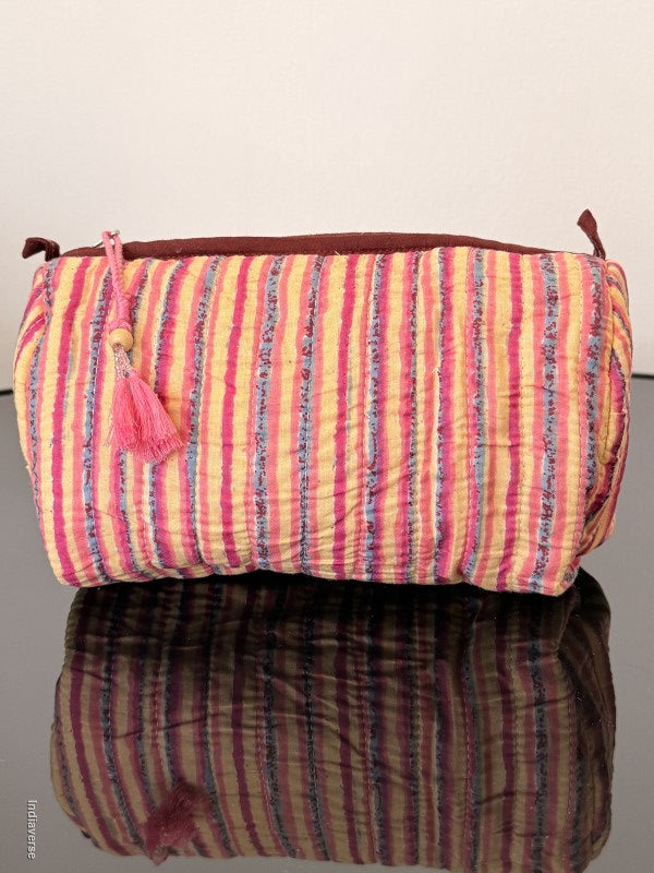 Two fabric rolls, one striped pink and yellow, the other brown and blue, on a light gray background.